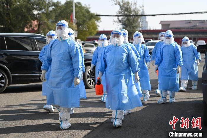 圖為醫(yī)務(wù)人員在封閉小區(qū)做防控工作?！⑽娜A 攝