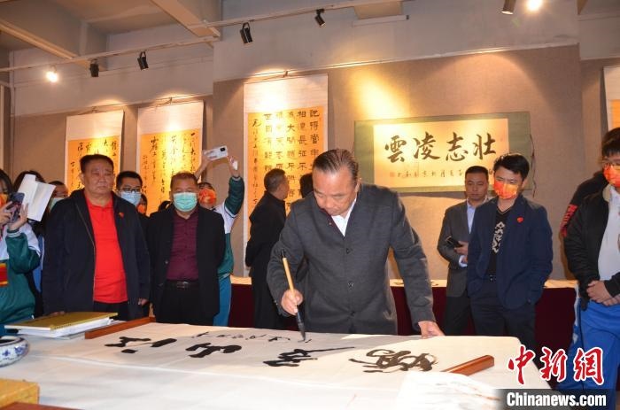 圖為“鐵軍老戰(zhàn)士”、著名書法家、解放軍報(bào)原副總編輯連俊義少將現(xiàn)場揮毫?！☆佇玛?攝 攝