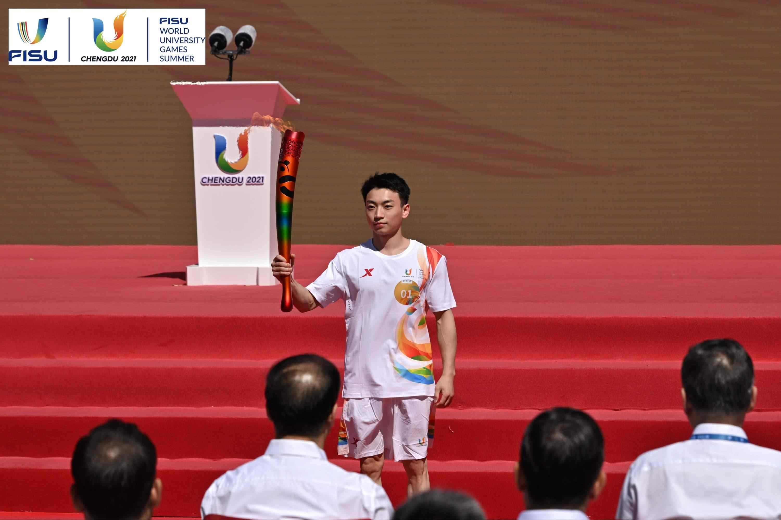 成都大運會火炬手、奧運冠軍鄒敬園高舉火炬。 圖片來源：成都大運會執(zhí)委會供圖