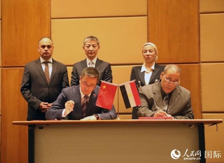 中國(guó)駐埃及使館公使張朝陽(yáng)與埃環(huán)境事務(wù)署工程和項(xiàng)目管理局局長(zhǎng)阿卜杜勒阿齊茲簽署交接證書(shū)。沈小曉攝