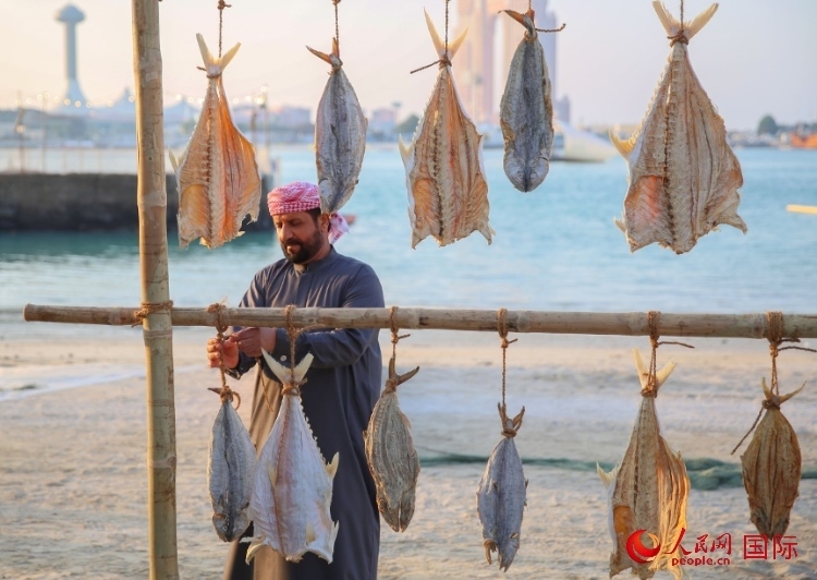  手工藝者展示如何晾曬魚干。人民網(wǎng) 塔里克·易卜拉欣攝