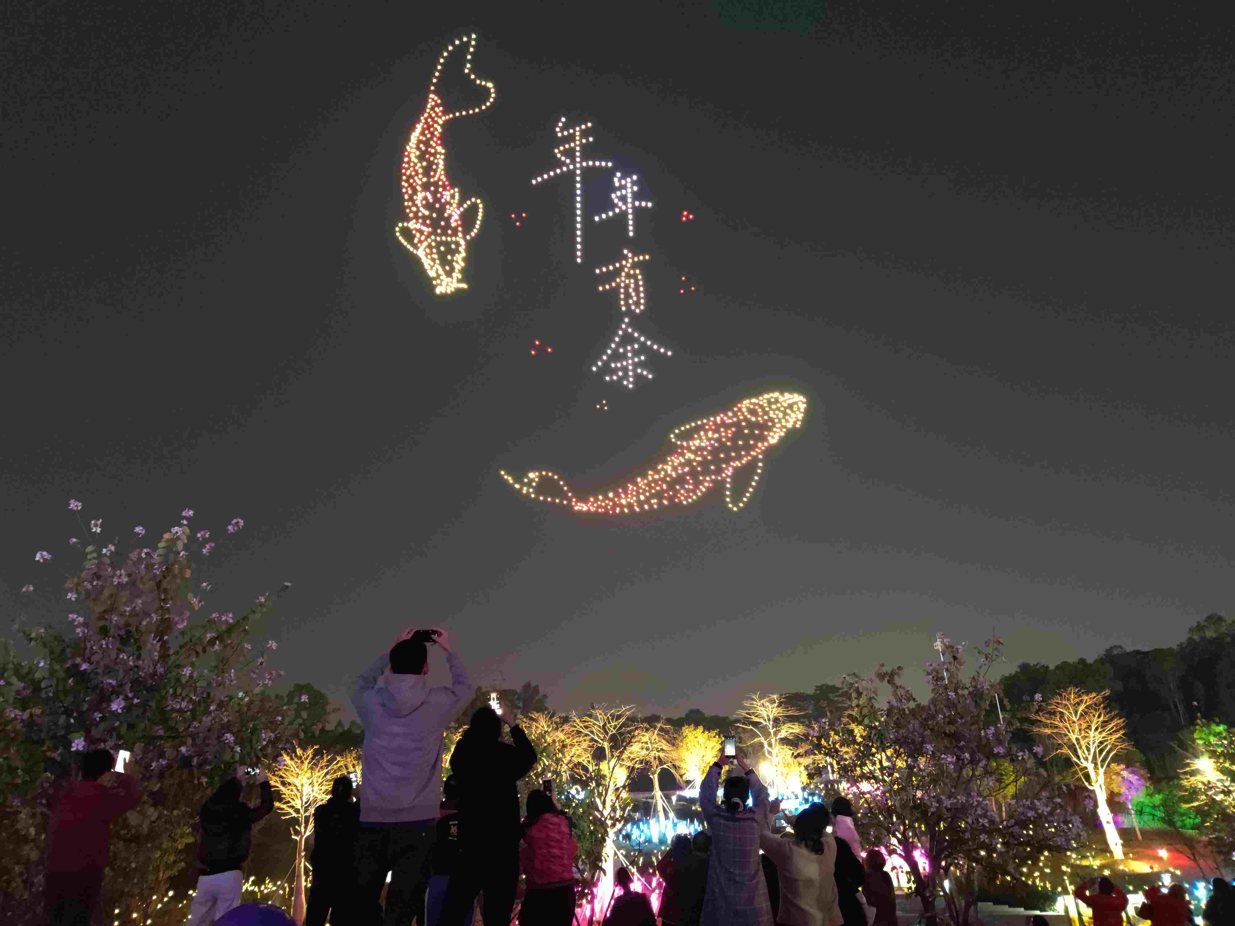 △ 2024年2月10日，深圳北站中心公園，春節(jié)主題無(wú)人機(jī)燈光秀引來(lái)眾多游客駐足觀看。