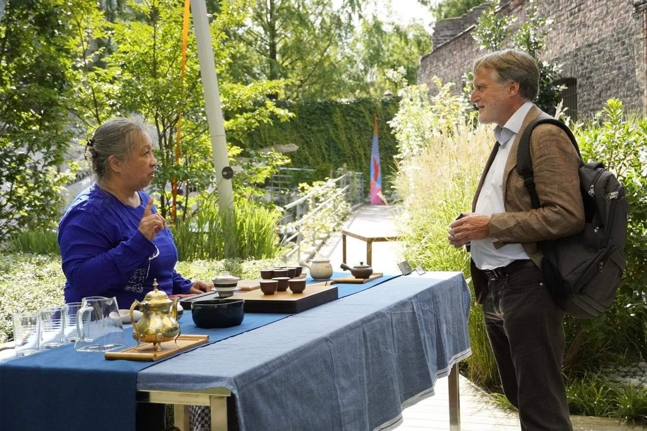 在博物館的戶外花園來賓品味中國茶藝。比利時(shí)維他命文化傳媒供圖