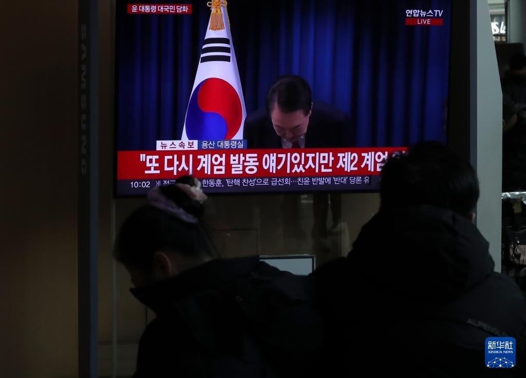 12月7日，在韓國首爾火車站，民眾觀看總統(tǒng)尹錫悅發(fā)表講話的電視畫面。新華社記者 姚琪琳 攝