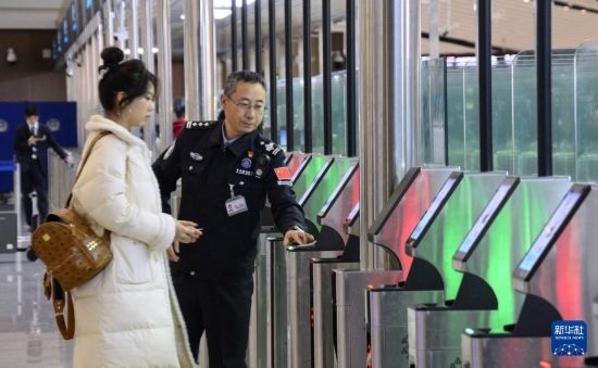 1月2日，大興機(jī)場(chǎng)邊檢站警察指導(dǎo)旅客使用自助出境設(shè)備。新華社記者 李欣 攝