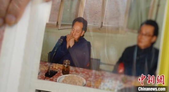 2月7日，劉潤林展示1986年黃旭華(左)在同樂會上吹口琴的老照片。中新社記者 鄒浩 攝